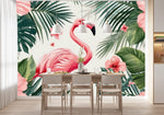 Papier Peint Panoramique Animaux De La Foret Exotique dans une salle à manger contemporaine avec table en bois naturel, chaises beiges et éclairage suspendu blanc. Illustration d'une scène tropicale avec un flamant rose au centre, entouré de grandes feuilles vertes et de fleurs d'hibiscus rose vif, avec des papillons roses volant autour.