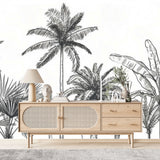 Papier Peint Jardin Tropical dans un salon de style scandinave avec buffet en bois clair et décoration minimaliste. Illustration d'une scène tropicale avec des palmiers et des arbres exotiques, dessinée en noir et blanc avec des détails fins et des contours nets, dans un style linéaire et minimaliste.