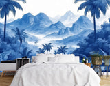 Papier Peint Foret Bleu dans une chambre à coucher apaisante avec lit blanc, table de chevet moderne, et plantes vertes. Illustration d'un paysage tropical avec des montagnes en arrière-plan, des palmiers et une végétation dense au premier plan, dans un style artistique surréaliste avec une palette de couleurs monochromatique bleu.